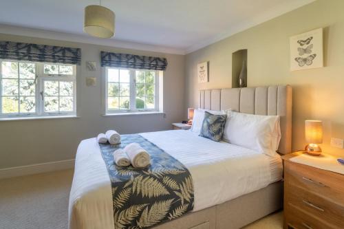 une chambre avec un grand lit avec des serviettes dessus dans l'établissement Westgate Cottage Thornham, à Thornham