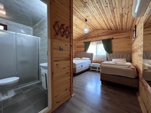 a bathroom with a shower and a toilet and a sink at mercan pension in Olympos