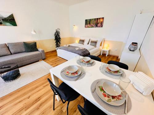 a living room with a white table and chairs at Apartment Miramare in Neunkirchen