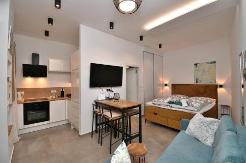a living room with a blue couch and a kitchen at Apartment Leprin in Labin