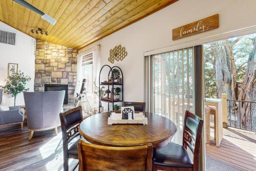 a living room with a wooden table and chairs at Sweet Strawberry Cabin in Pine