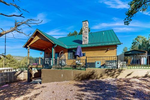 a log cabin with a green roof at Sweet Strawberry Cabin in Pine