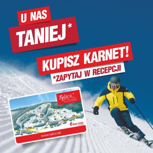 a man is skiing down a snow covered slope at Willa Hamernik AGROTURYSTYKA in Tylicz