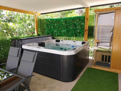 a hot tub in the middle of a patio at Adriatic SPA Apartment in Selce