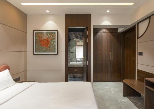 Ένα ή περισσότερα κρεβάτια σε δωμάτιο στο Orbit Serviced Apartments