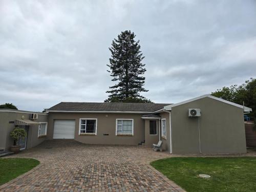 a house with a tree in the back yard at BestInn in Lorraine