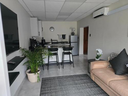 a living room with a couch and a kitchen at BestInn in Lorraine
