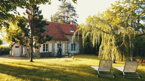two chairs sitting in the yard of a house at LE PRESBYTERE in Chasnay