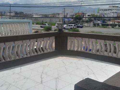 a white fence with a view of a street at Bobby Vacational Home in Portmore