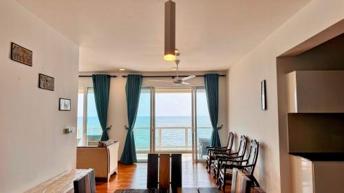 a living room with a view of the ocean at Luxury Oceanfront Penthouse in Uswetakeiyawa in Uswetakeiyawa