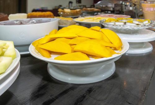 a table topped with plates of food on a table at Hotel Vila Rica Belém in Belém