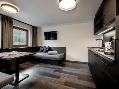 a living room with a couch and a table at The Black by Regina in Sölden