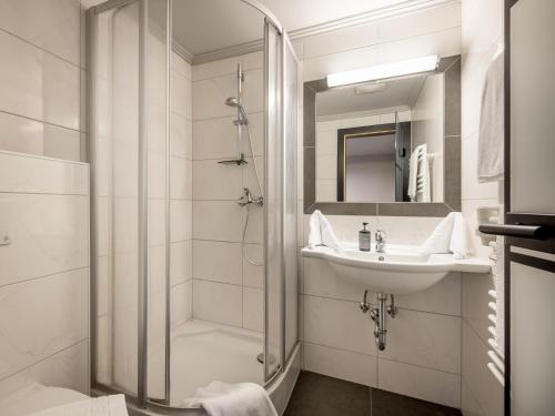 a bathroom with a shower and a sink at The Black by Regina in Sölden