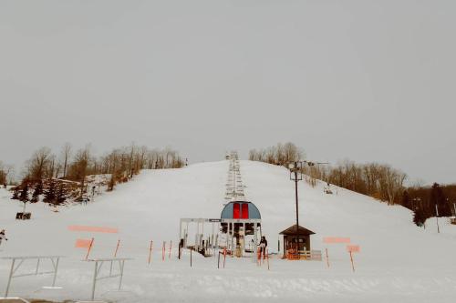 a ski slope with a ski lift in the snow at Private Cabin-Shuttle Pass Included! in Thompsonville