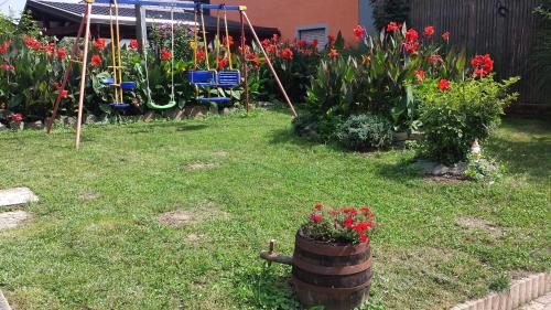 a garden with colorful flowers in a yard at Apartments Akacijev Izvir in Miklavž na Dravskem Polju