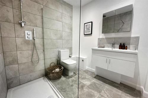 a bathroom with a shower and a toilet and a sink at River Breeze 3-Bed BALCONY Apartment in Littlehampton
