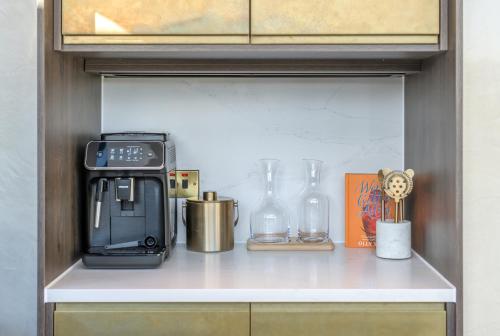 a kitchen shelf with a coffee maker and other items at RÌGH Residences - George Street in Edinburgh
