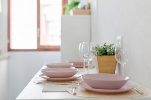 a table with bowls and plates and wine glasses at Martimar Candelaria in Candelaria