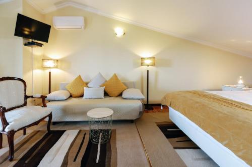 a hotel room with two beds and a chair at Suíte Private balcony Hot Tub in Aguda