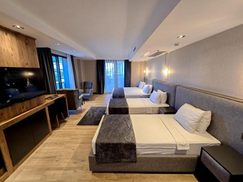a row of beds in a hotel room at AYATOURE HOTEL in Bulancak