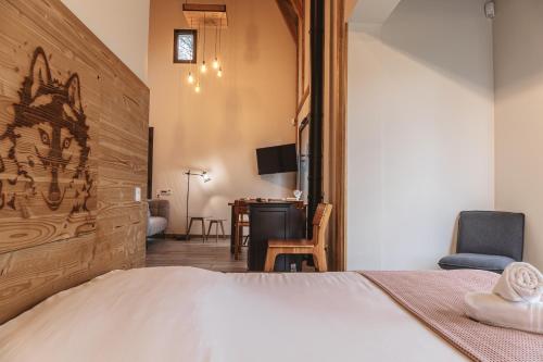 a bedroom with a large bed and a desk at Village de gîtes de Sainte-Lucie in Sainte-Lucie