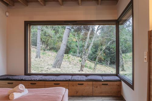 a window in the bedroom of a forest house at Village de gîtes de Sainte-Lucie in Sainte-Lucie