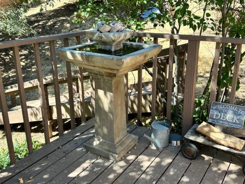 a stone fountain sitting on a wooden deck at Time Traveler Retreat in Julian