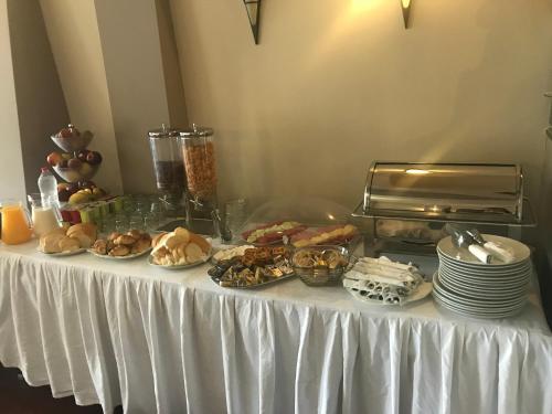 a table with plates of food on top of it at Hotel Pejton in Pristina