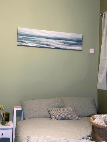 a painting hanging on a wall above a couch at The Rosemary Stay in Hull