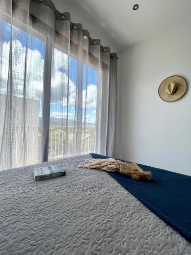 a bedroom with a large window and a large bed at Résidence Storia di Blue in Porto-Vecchio