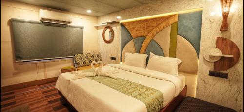 a bedroom with a large bed in a room at Victoria Houseboats in Alleppey