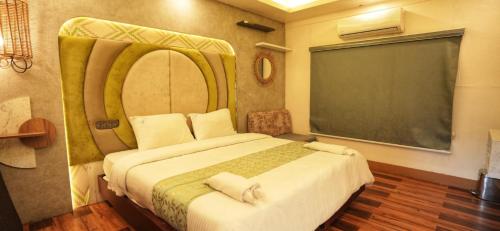 a bedroom with a large bed and a chalkboard at Victoria Houseboats in Alleppey