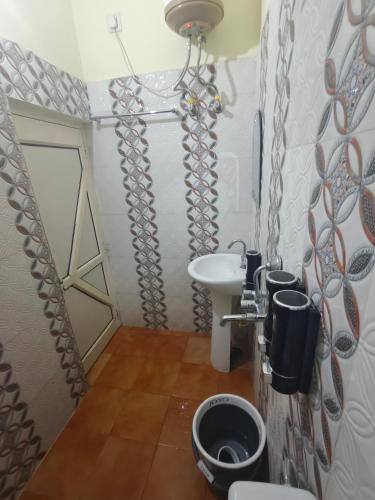 a small bathroom with a sink and a toilet at Mild Life Hostel Rishikesh in Rishīkesh