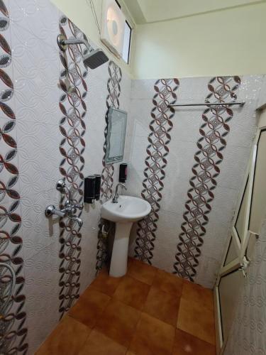 a bathroom with a sink and a mirror at Mild Life Hostel Rishikesh in Rishīkesh