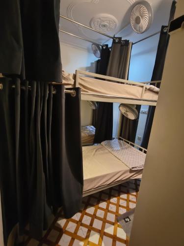 a room with two bunk beds with curtains at Mild Life Hostel Rishikesh in Rishīkesh