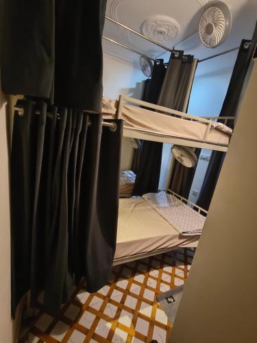 a room with two bunk beds and a curtain at Mild Life Hostel Rishikesh in Rishīkesh