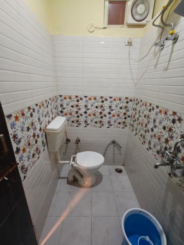 a bathroom with a toilet and a sink at Mild Life Hostel Rishikesh in Rishīkesh