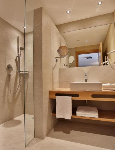 a bathroom with a sink and a shower at Noldis Apart in Serfaus