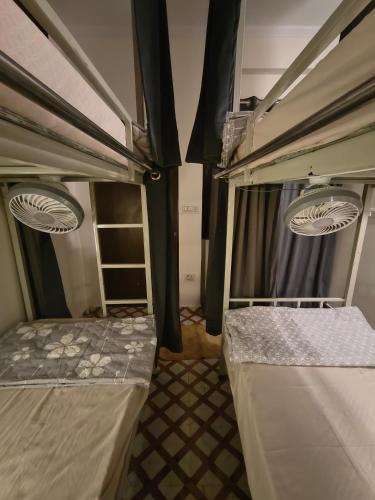 a room with two bunk beds in a room at Mild Life Hostel Rishikesh in Rishīkesh