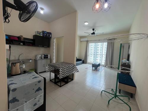 a living room with a table and a kitchen at Sandakan Homestay & Backpackers in Sandakan