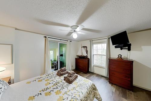 a bedroom with a bed and a flat screen tv at Mariner's Reach in Sullivan