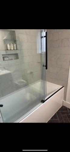 a white shower with a glass door in a bathroom at Sparrowhawk House in Yarmouth