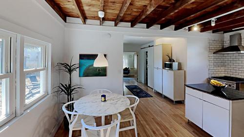 a kitchen and dining room with a table and chairs at Sparrowhawk House in Yarmouth