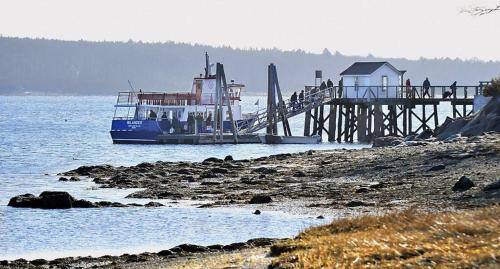 a boat on the water near a pier at Sparrowhawk House in Yarmouth