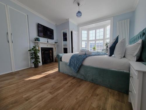 a bedroom with a large bed and a fireplace at Ingleside Mews in Whitby