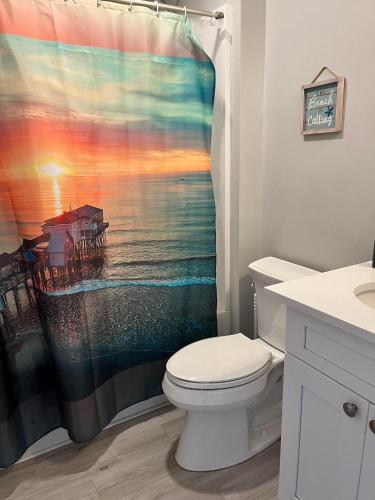 a bathroom with a toilet and a shower curtain at Lido Deck 101 in Old Orchard Beach