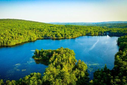 an aerial view of a lake surrounded by trees at Water's Edge in Bucksport