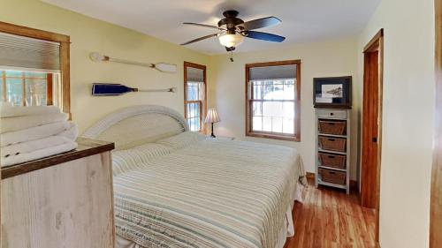 a bedroom with a bed with a ceiling fan at Wolfe's Way in Franklin