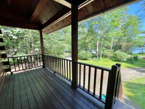 a porch of a house with a view of the woods at Bucksport Bliss in Bucksport