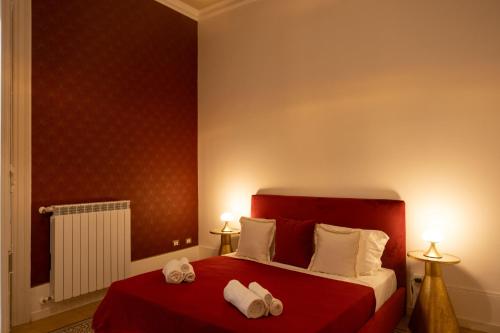 a hotel room with a bed with towels on it at Il Sipario Luxury Apartments in Palermo